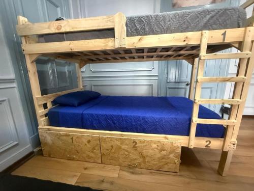 a bunk bed in a room with a blue bed at Familyhostel in Santiago