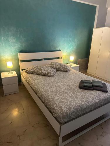 a bedroom with a bed with two pillows and two lamps at B&B SICILIA in Messina