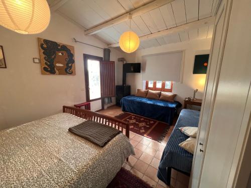 a bedroom with a bed and a couch at La Rosa dei Monti Iblei in Ferla