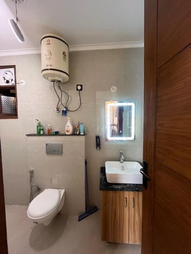 a bathroom with a toilet and a sink at 3BHK Independent Floor in New Delhi