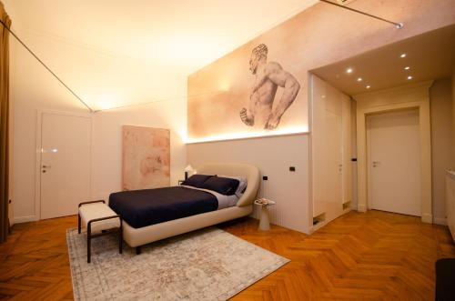 a bedroom with a bed and a painting on the wall at The Orso Suite -Brera in Milan