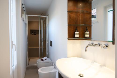 a bathroom with a sink and a toilet at The Orso Suite -Brera in Milan