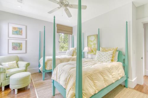 a bedroom with two beds and a ceiling fan at 119 Halona Ln in Kiawah Island