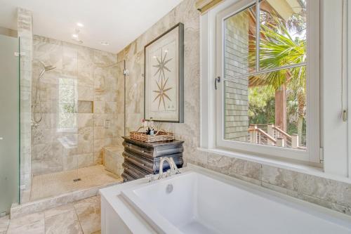 a bathroom with a tub and a shower and a window at 119 Halona Ln in Kiawah Island