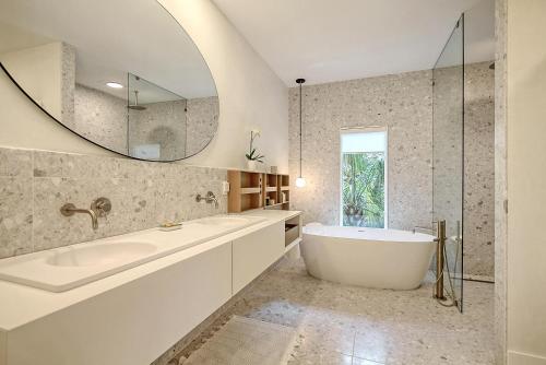 a bathroom with a tub and a mirror at 217 Glen Abbey in Kiawah Island