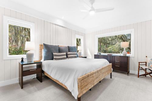 a bedroom with a large bed and two windows at 2455 The Bent Twig in Seabrook Island