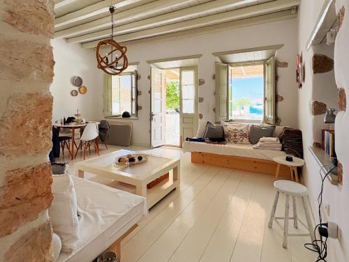 a living room with a couch and a table at Agnanti Beach House in Patmos