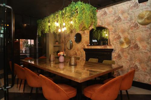 a dining room with a table and orange chairs at Hotel 1843 Reading in Reading