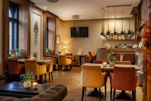 a restaurant with tables and chairs and a bar at City Residence Apartment Hotel in Košice