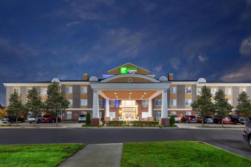 a hotel building with a sign on top of it at Holiday Inn Express Hotel & Suites Woodhaven by IHG in Woodhaven