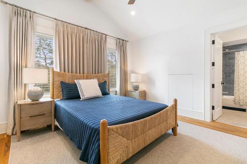 a bedroom with a blue bed and a window at 117 Halona in Kiawah Island