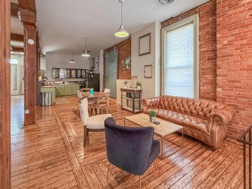 a living room with a leather couch and a table at Loft 40 in Cleveland