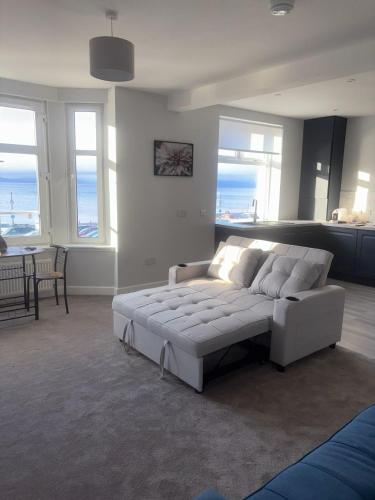 a living room with a large white bed in a room at Skips in Largs