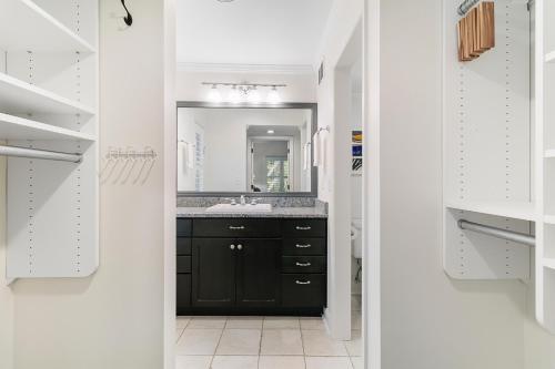 a bathroom with a black vanity and a mirror at 5537 Green Dolphin Way in Kiawah Island