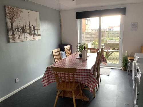 a dining room with a table and chairs and a window at 5 BedRm Hse! Ev! & Nr CityCentre! in Manchester