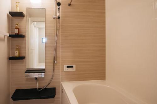 a bathroom with a bath tub and a sink at Tokyo stay 365 in Tokyo