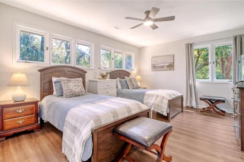 a bedroom with two beds and a ceiling fan at 273 Summer Tanager in Kiawah Island