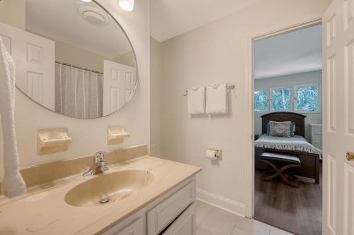 a white bathroom with a sink and a mirror at 273 Summer Tanager in Kiawah Island