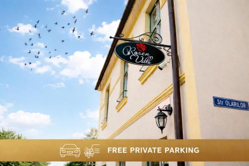 a sign on the side of a building with birds flying in the sky at Rosen Villa Sibiu in Sibiu