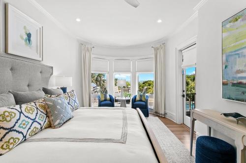 a bedroom with a bed and a desk with blue chairs at 38 Surfsong in Kiawah Island