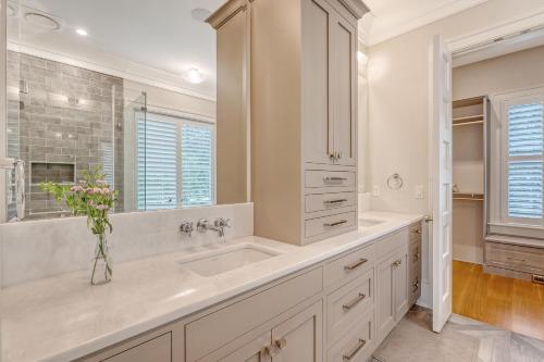 a white bathroom with a sink and a mirror at 68 New Settlement in Kiawah Island