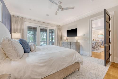 a bedroom with a large white bed and a television at 68 New Settlement in Kiawah Island