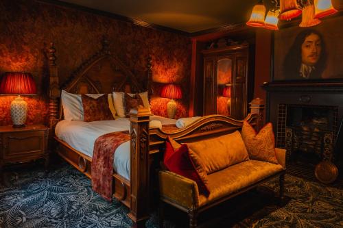 a bedroom with a bed and a chair at Golden Fleece York in York