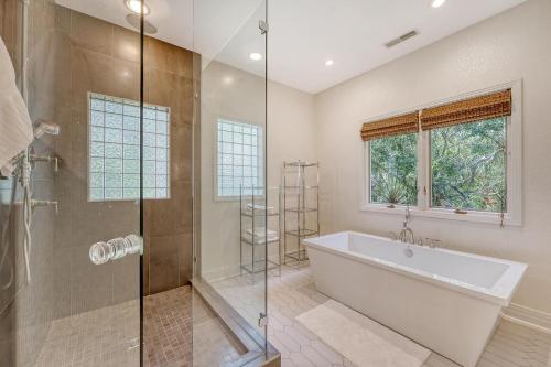 a bathroom with a tub and a glass shower at 338 Surfsong in Kiawah Island