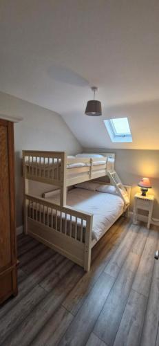 a bedroom with two bunk beds and a window at Yellow Stone Farm Lodge and Spa in Clonbrown