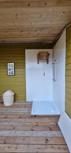 a room with a white door on a wooden floor at Yellow Stone Farm Lodge and Spa in Clonbrown
