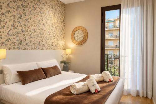 a bedroom with a bed with two pillows on it at Sagrada Familia Xamfrà in Barcelona