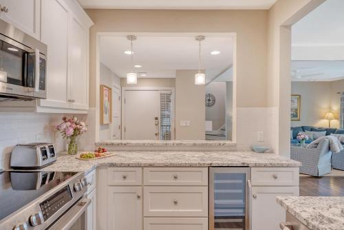 a kitchen with white cabinets and a large mirror at 4925 Green Dolphin in Kiawah Island
