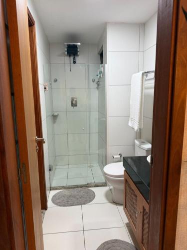 a bathroom with a shower and a toilet at Apartamento em Resort para família in Barra de São Miguel