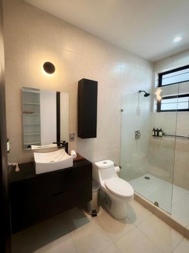 a bathroom with a toilet and a sink and a shower at "Casa Mosso" en San Felipe del Agua in Oaxaca City