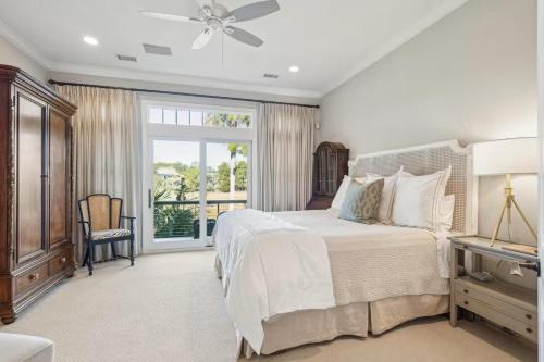 a bedroom with a large bed with a ceiling fan at 711 Glossy Ibis in Kiawah Island