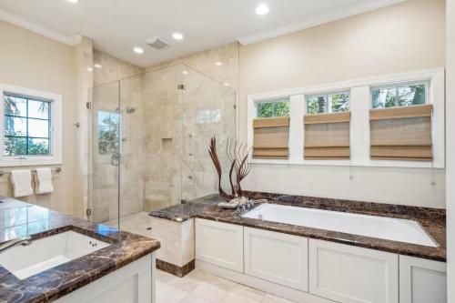a bathroom with two sinks and a shower at 711 Glossy Ibis in Kiawah Island