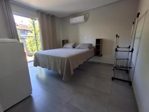 a bedroom with a bed and a ladder in it at Apartamento novo - 2 Quartos Casal até 4 pessoas - Centro - Santa Rosa - RS in Santa Rosa