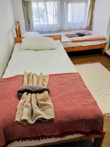 a bedroom with two beds with towels on the bed at GuestHouse2 Karma369 in Plovdiv