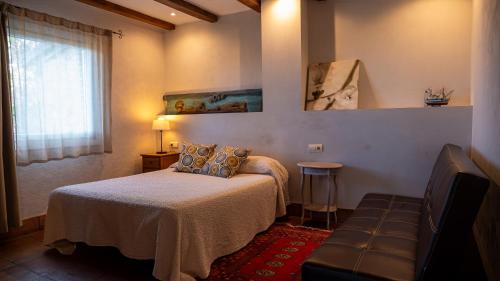 a bedroom with a bed and a couch and a window at Igeldo in Orio