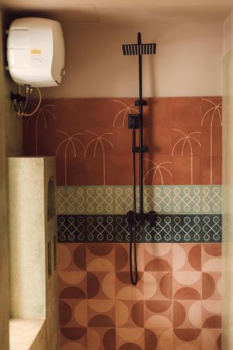 a bathroom with a shower with a toilet and a sink at Meli Beach in Galle