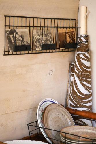 a shelf on a wall with plates on it at Grande maison de ville MALO LEONE 250m2 pour 15 personnes proche du Puy du Fou in Mauléon