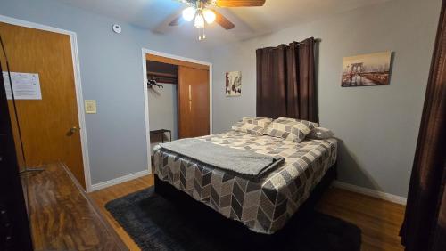 a bedroom with a bed and a ceiling fan at Gano Street Retreat in Great Bend
