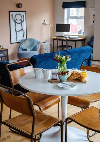 a table with bowls of food on it in a living room at Seaside 2Bed En-suite Flat, Parking by Adliv in Margate