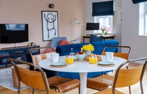 a dining room with a white table and chairs at Seaside 2Bed En-suite Flat, Parking by Adliv in Margate