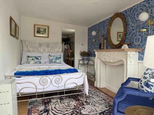 a blue and white bedroom with a bed and a mirror at Lakeside Haven in The Hyde