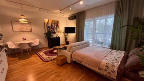 a bedroom with a bed and a table and a dining room at Best Rest Apartments in Narva-Jõesuu