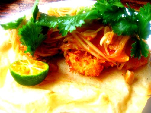 a plate of food with a taco and a lime at Guerrera Rice Paddy Villas in Mambajao