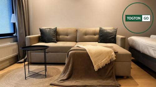 a living room with a couch and a table at Nice Växjö City Stay In Arenastaden Vida Arena in Växjö