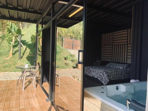 a room with a bed and a bath tub at Cabañas Ecologe BLESS in Chiquinquirá