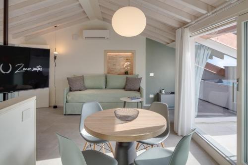 a living room with a table and chairs and a couch at Zeno Suites in Verona